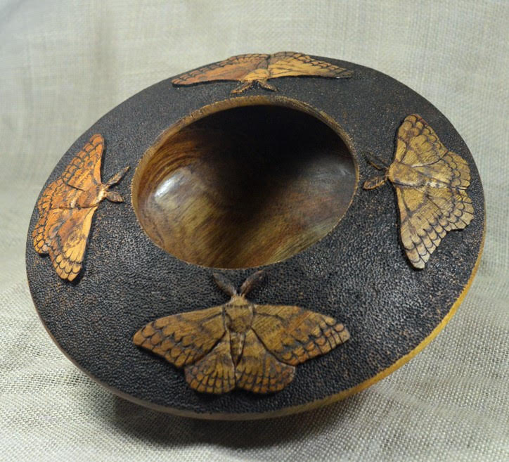 A hollow form engraved with butterflies by Dan Hall
