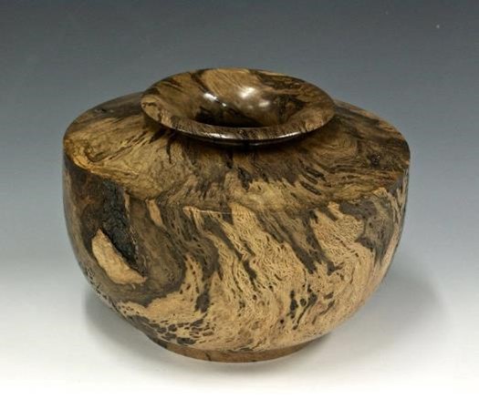 A hollow form engraved with butterflies by Dan Hall